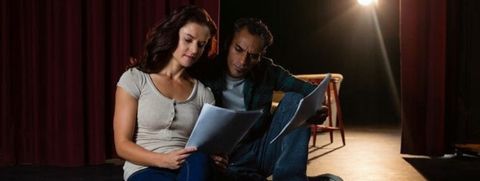 Photo credit: Actors on stage reading script Shutterstock